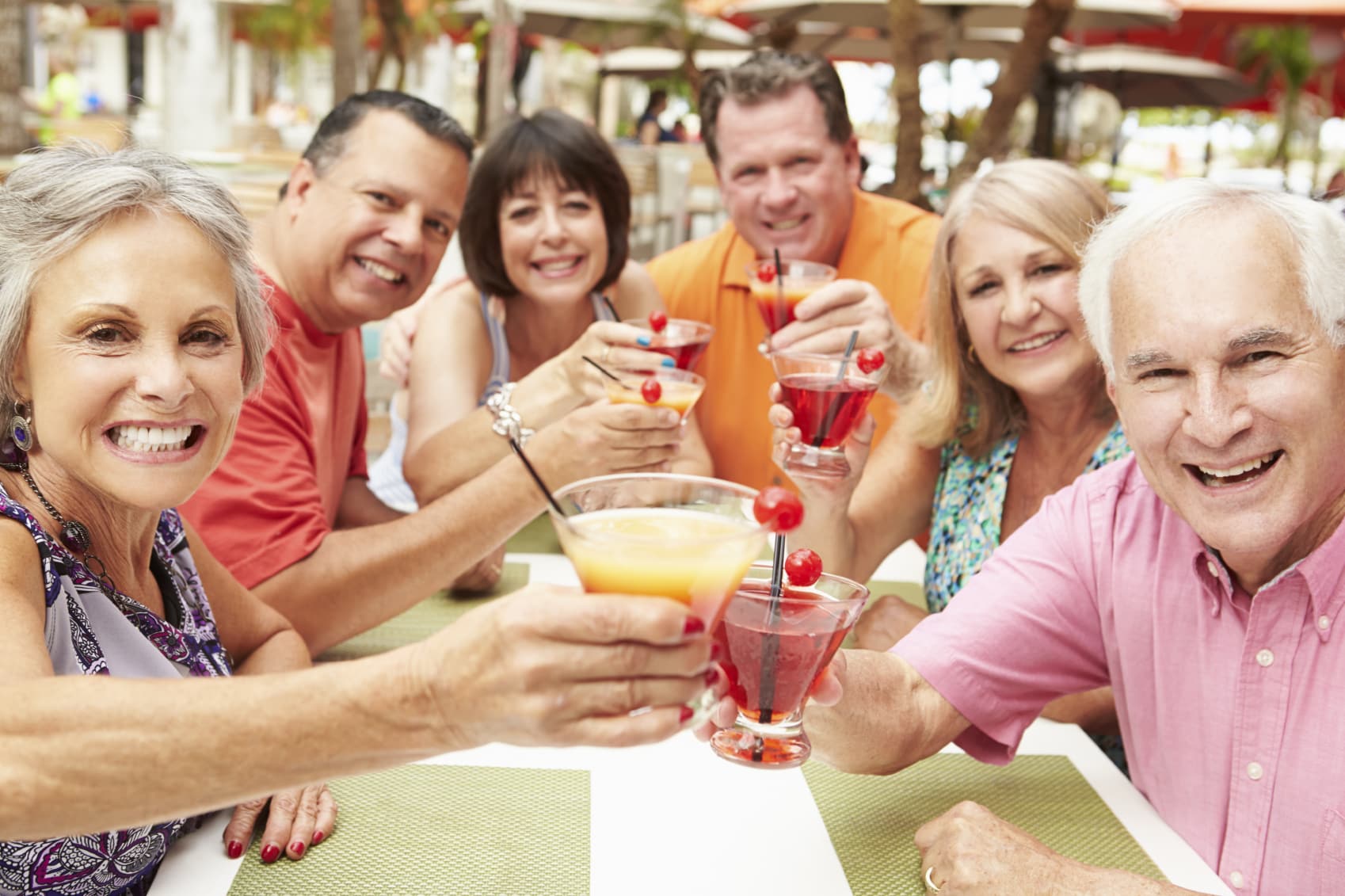 Group Of Senior Friends Enjoying Cocktails In Bar Together